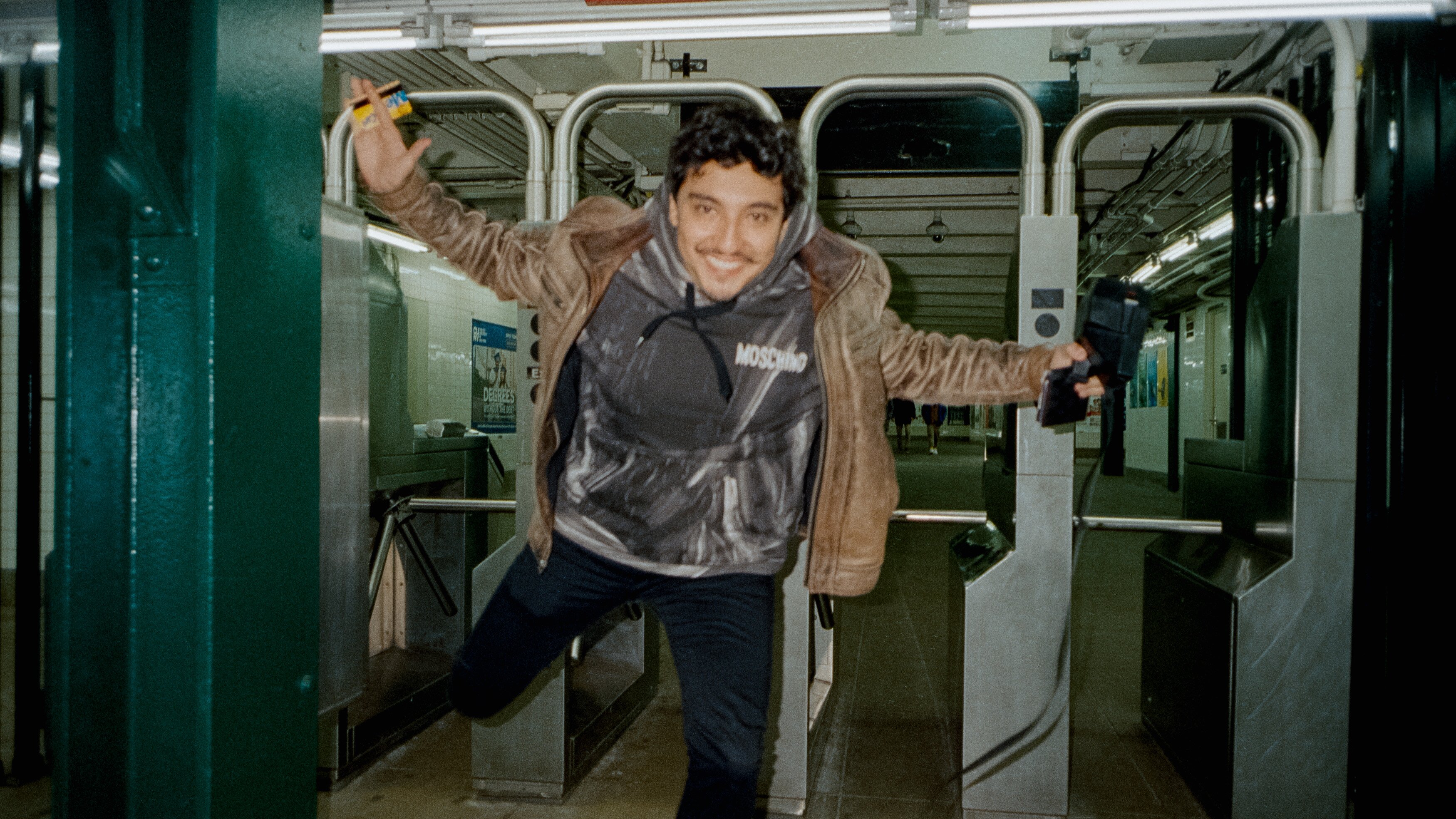 Director Carlos Felipe jumps out of the subway turnstiles
