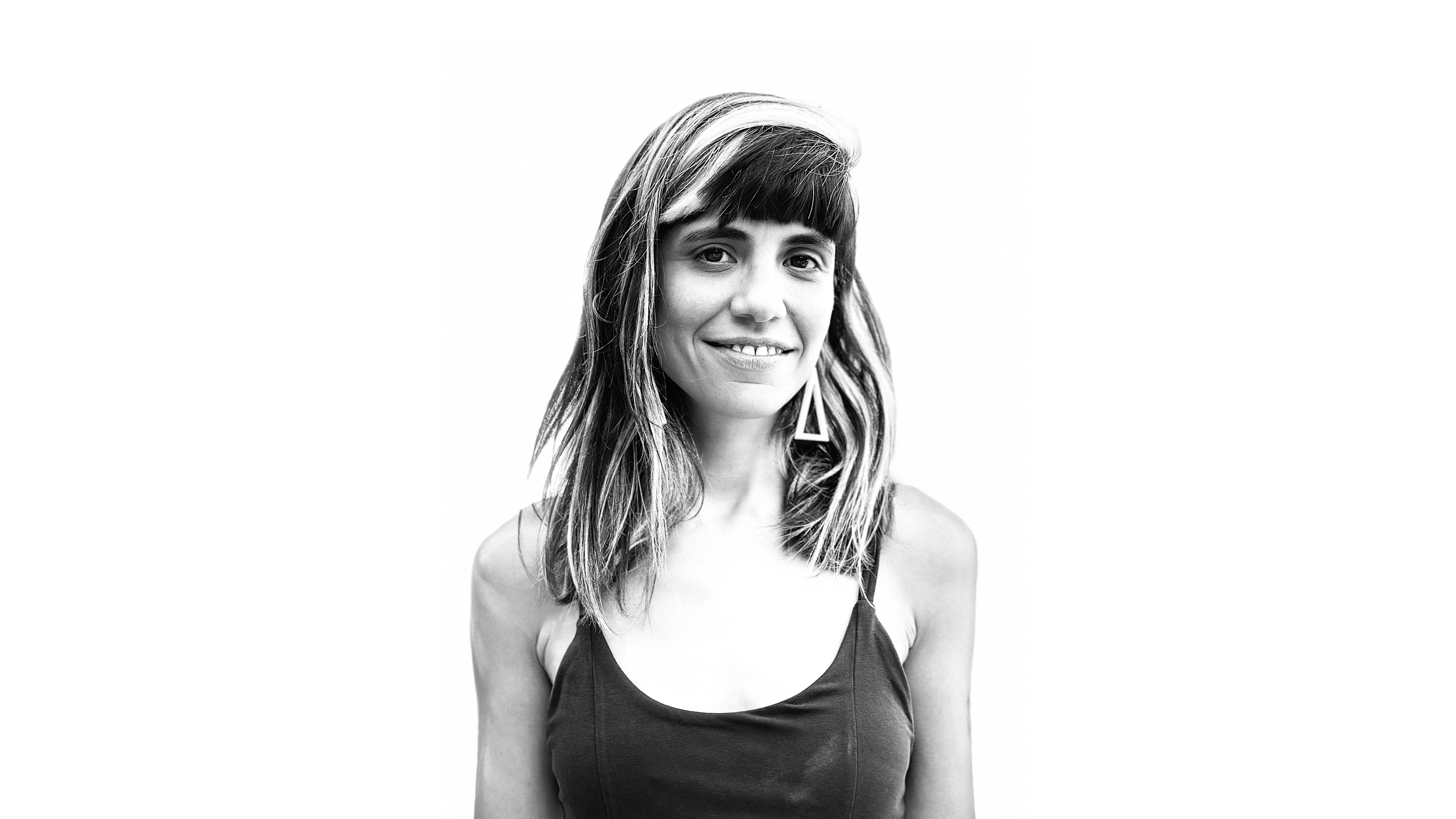 Director Celeste Lois smiles. Black and white portrait